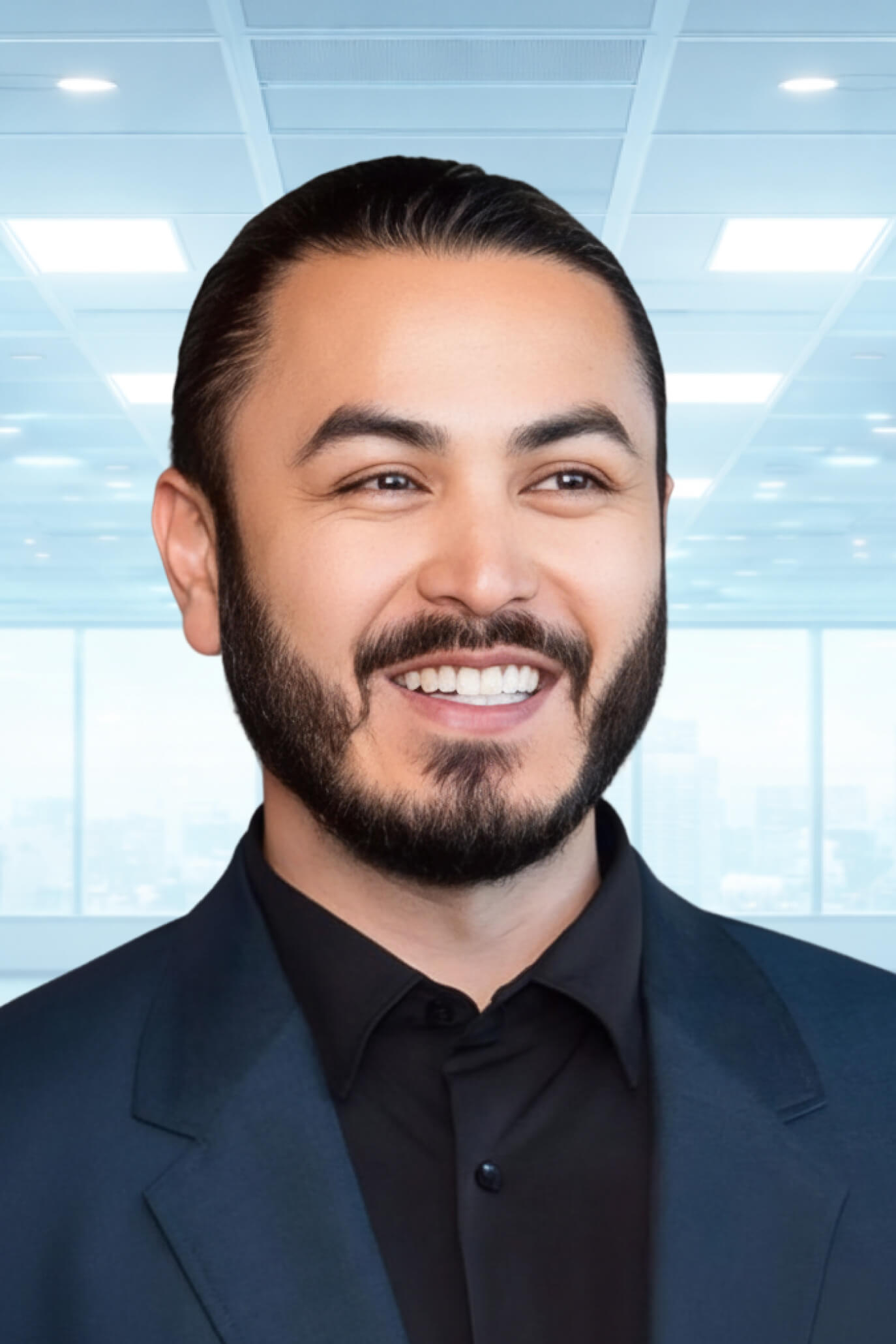 Christopher Park smiling in a dark suit and black shirt against a bright modern office background.